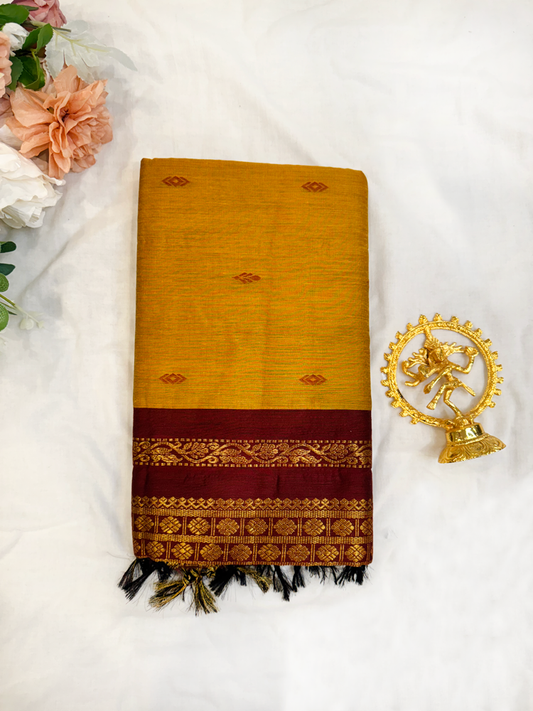 Ocher yellow Kalyani silk cotton saree with maroon pallu and traditional border