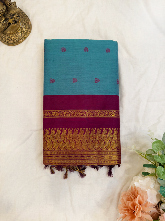 Slate blue kalyani silk cotton saree with dark purple pallu and golden peacock border