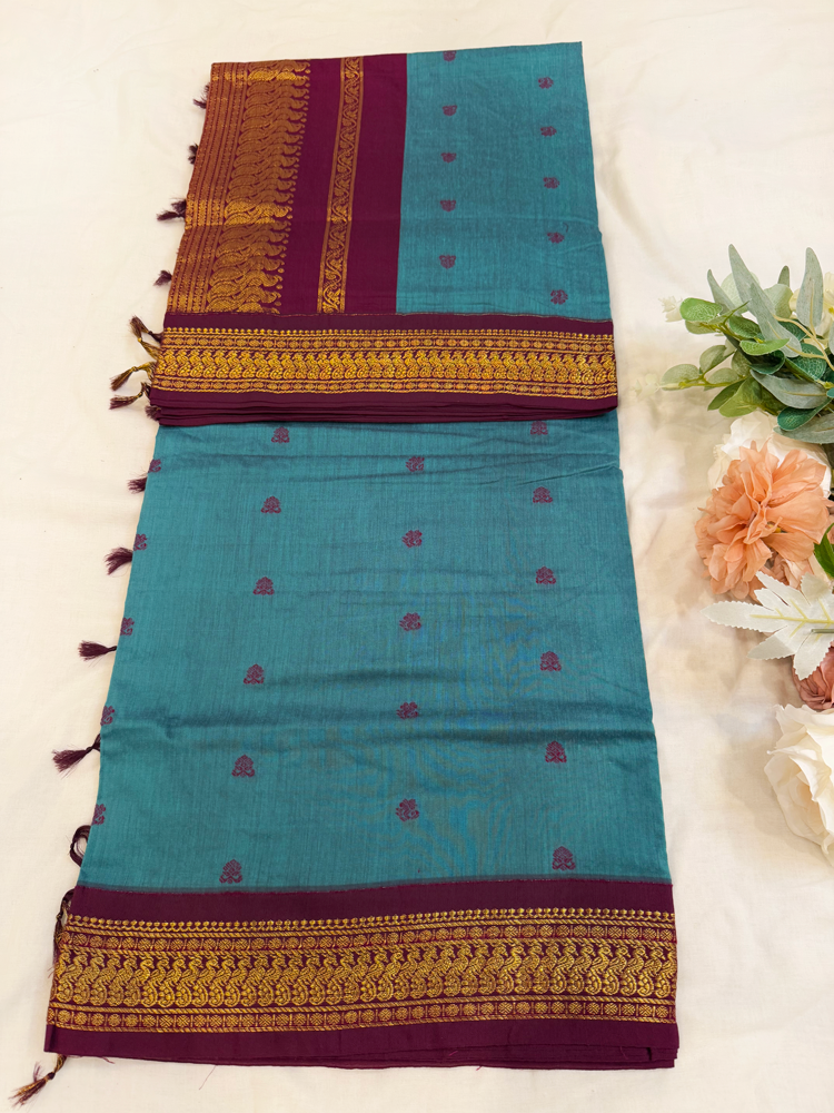 Slate blue kalyani silk cotton saree with dark purple pallu and golden peacock border