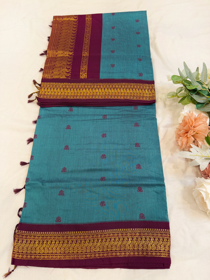 Slate blue kalyani silk cotton saree with dark purple pallu and golden peacock border