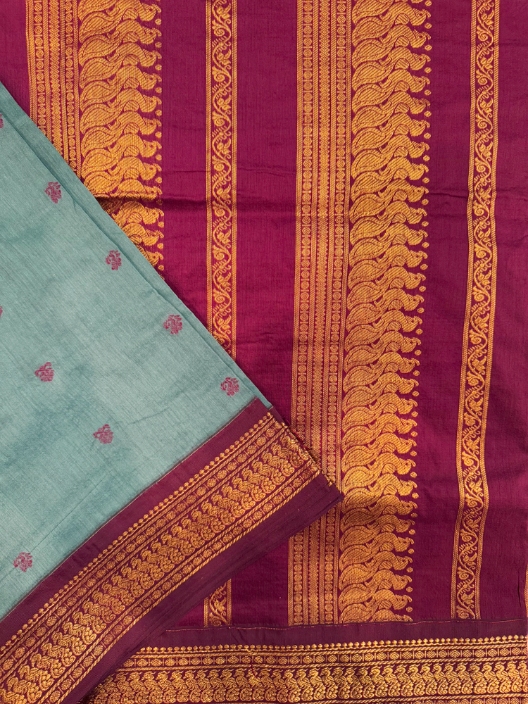 Slate blue kalyani silk cotton saree with dark purple pallu and golden peacock border