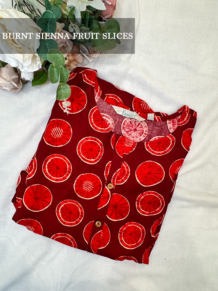 Red kurti with fruit slice pattern on a white background