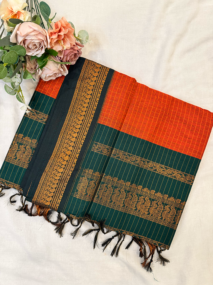 Kalyani silk cotton saree in orange checked pattern and green border. 
