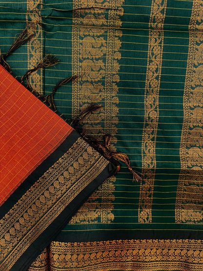 Kalyani silk cotton saree in orange checked pattern and green border. 