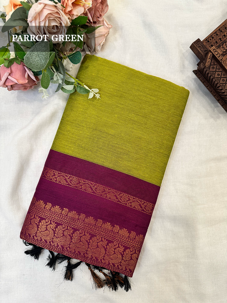 Parrot green kalyani silk cotton saree with purple peacock border
