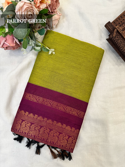 Parrot green kalyani silk cotton saree with purple peacock border
