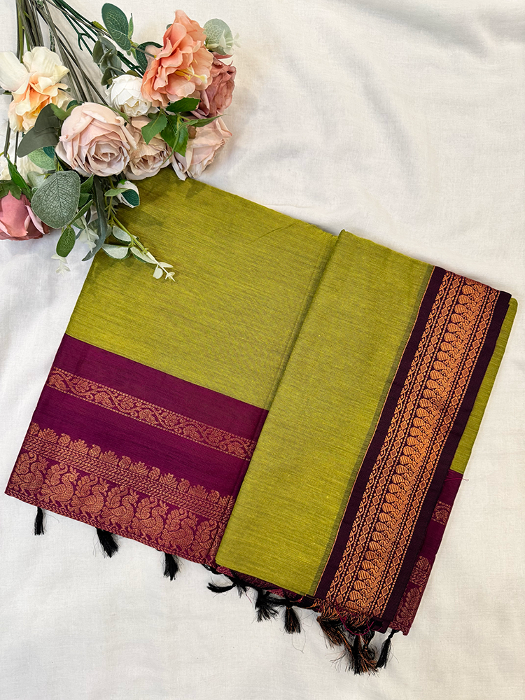 Parrot green kalyani silk cotton saree with purple peacock border