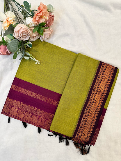 Parrot green kalyani silk cotton saree with purple peacock border