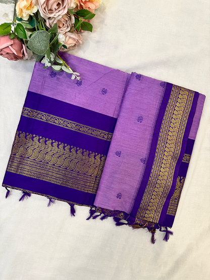 Purple kalyani silk cotton saree with gold patterns on a white background