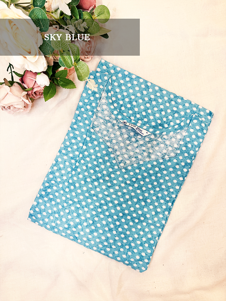 Blue polka dot kurti on a light background, surrounded by flowers.